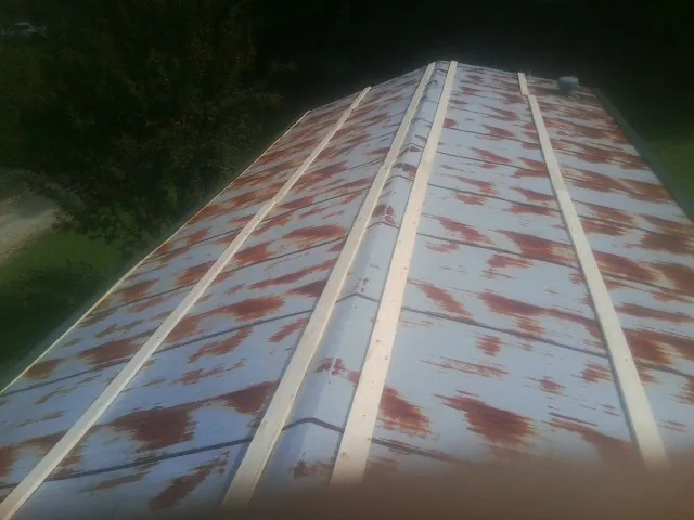 Rusted metal roof panels with new wood purlins before replacement — Storm Damage Roof Repair in Egg Harbor City by Roofing Brothers