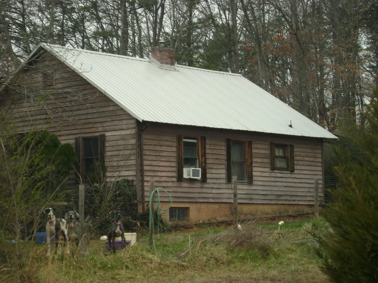 White metal roof on an old wood sided farmhouse, from a Metal Roof Installation job in Egg Harbor City